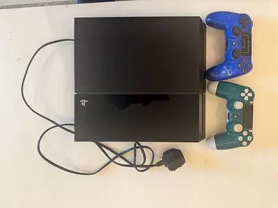 PlayStation 4 Slim with 2 DualShock Controllers (Good Working Condition)