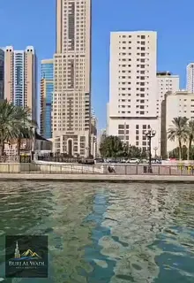 Apartment for sale in Sharjah/Al Qasba, Rose Towers 1, with a direct view of Al Khan Lake, at a grea