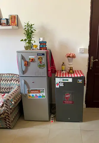 Two compact refrigerators - small double-door fridge and single-door mini fridge (good condition)
