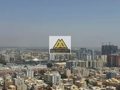 Prime Location with Direct Access to Sharjah & Dubai Exit | High Floor with Open View | 2 Balconies | Closed Kitchen | Central AC | Free Maintenance b