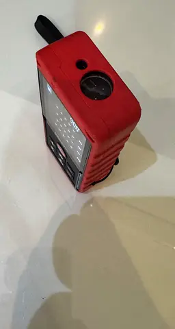 Portable handheld digital multimeter in red casing - used
