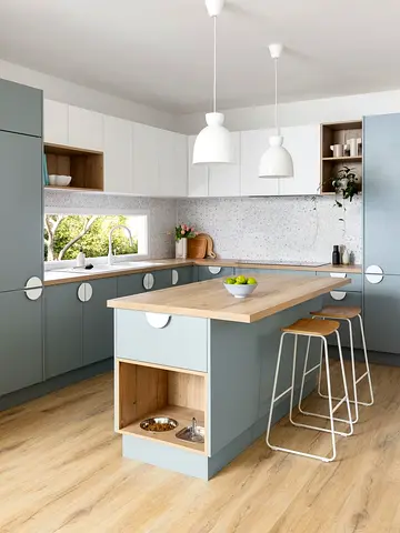 Modern light blue kitchen with island and pendant lights