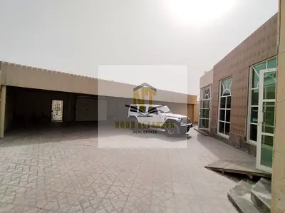 Two adjacent villas for sale in Al Ghafia, Sharjah, on a plot of 19,600 sq ft, featuring 12 bedrooms, majlis (formal sitting rooms), living rooms, ext