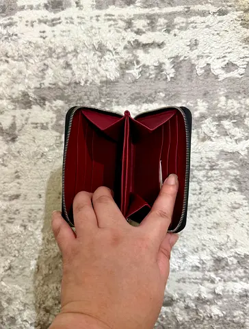 Compact zip-around womens wallet - black exterior, red interior
