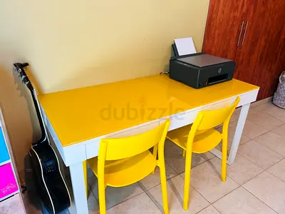 White and yellow double study desk with two yellow chairs