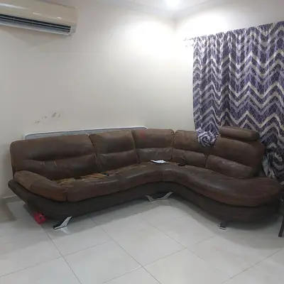 Brown leather L-shaped sectional sofa - comfortable seating, needs minor repair