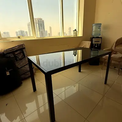 Dining Table for Sale – AED 150 (Negotiable)

Modern black dining table with a sleek glass top and s