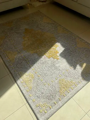 Light grey and gold patterned area rug - good condition