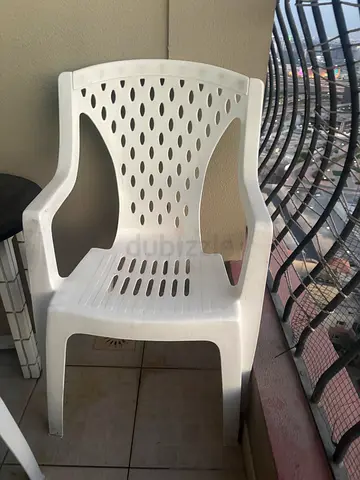 Plastic chairs with round wooden table