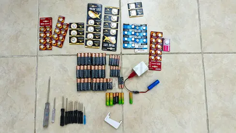 Selection of assorted batteries and chargers (coin cells, AA/AAA, rechargeable)
