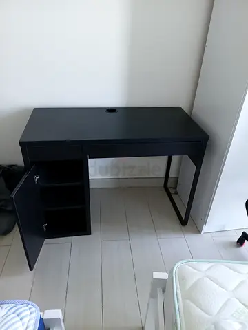 Compact black study desk with storage cubbies