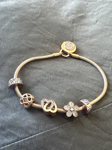 original pandora Silver charm bracelet with multiple decorative charms (used)