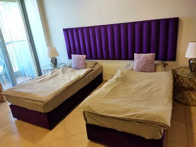 Pair of Single Beds with Padded Purple Headboard