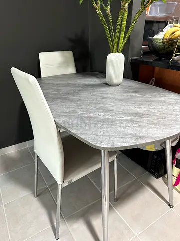 Compact grey dining table with 2 white chairs