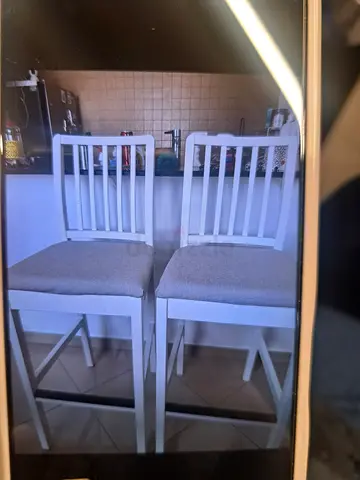Pair of white wooden dining chairs with grey seats