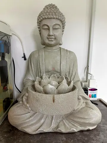large decorative Buddha statue with lotus candle holder