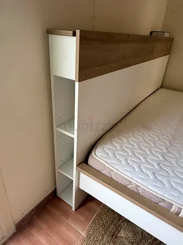 Wood and white platform bed frame with built-in storage shelves. Queen bd with the mattress.