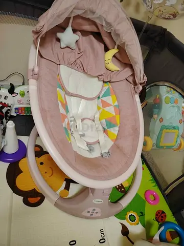 Gently used pink baby rocker/seat with canopy and toy mobiles