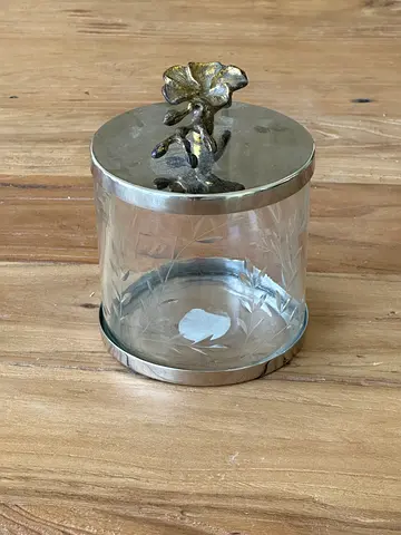 Small decorative glass jar with metal lid