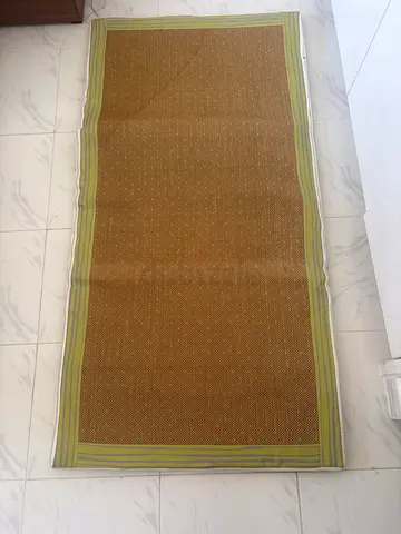Light brown woven area single bed mattress with green border - good condition