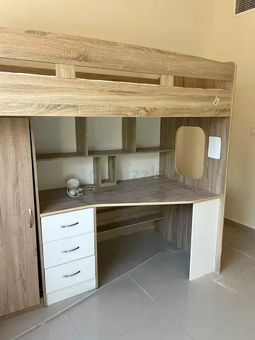 Wooden loft bed with built-in desk, drawers and shelves