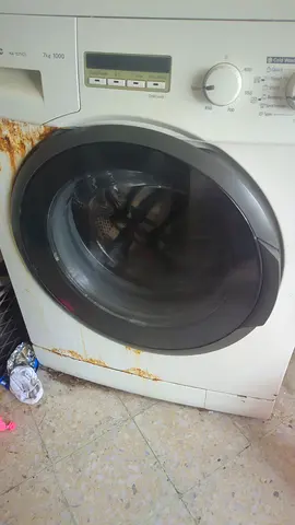 Used front-load washing machine - needs minor repair (rust on door area)