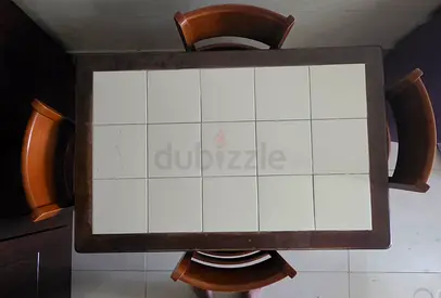 Wooden dining table with white tiled top and 4 chairs