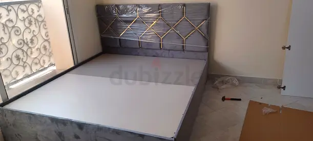 Gray upholstered double bed with padded headboard - good condition