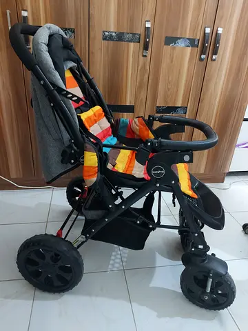 Used all-terrain baby stroller with reclining seat and storage basket.