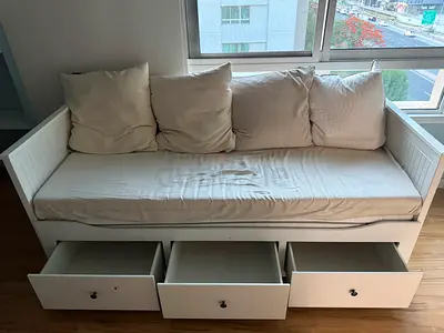 White wooden sofa bed with 3 under-drawers and cushions