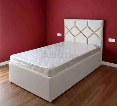 Single white upholstered bed with storage base and mattress