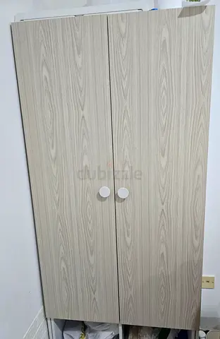 Two-door freestanding wardrobe in light wood finish - good condition