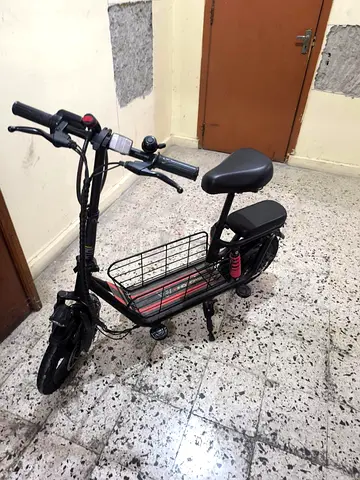 Compact electric scooter with seat and cargo basket - used
