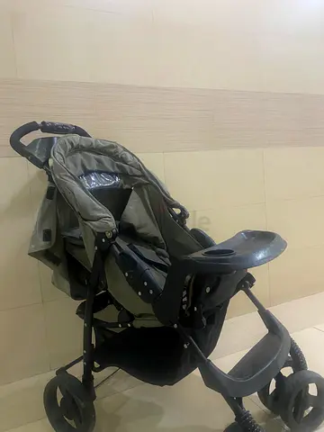 Used three-wheel baby stroller in good working condition