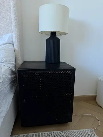 Black bedside cabinet / nightstand with cane front. 2 available, 100 aed each