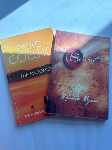 Two paperback novels: The Alchemist  The Secret by Paulo Coelho
