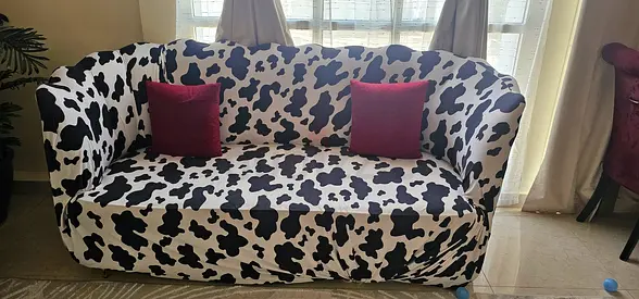 Five seater sofa with black-and-white cow print cover