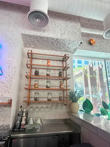 Wall-mounted wooden display shelf with glass rack