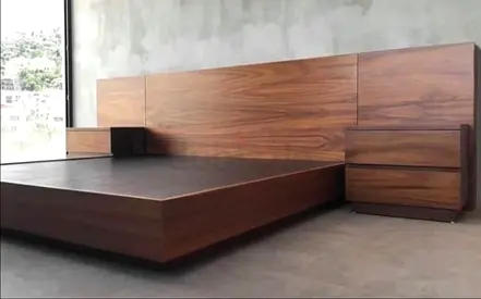 Modern low-profile wooden platform bed with integrated headboard and bedside drawers