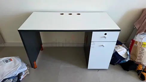 Simple white and grey desk with drawer and cable holes
