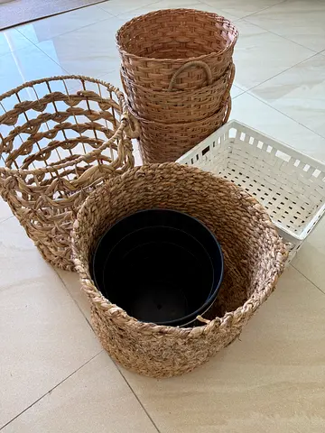 Set of woven storage baskets and plastic planters — used