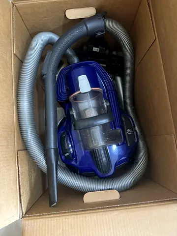 Compact canister vacuum cleaner with hose and attachments - used