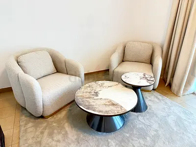 Pair of Cozy Bouclé Armchairs with Marble-Top Nesting Coffee Tables