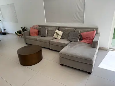 West Elm L-shaped fabric sofa with chaise, and coffee table.