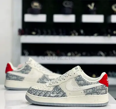 White Dior-patterned Air Force style sneakers with red heel