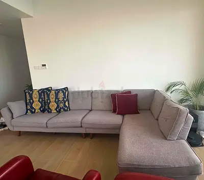 Grey upholstered L-shaped sofa