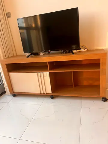 Light wood TV entertainment unit with storage shelves and cabinets