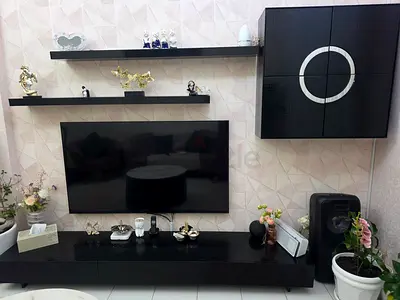 Modern black wall-mounted and floor TV stand set for entertainment unit with shelving