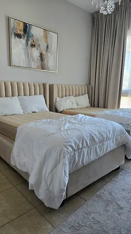 Beige upholstered single size bed with padded headboard from Pan homes