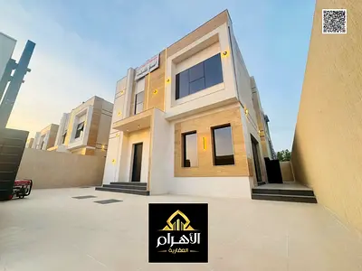 Villa for sale, including registration and ownership fees, near all services, close to Sheikh Mohammed Bin Zayed Road, on a main street, very prime lo